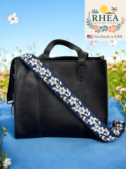 Rhea Artistry Studio navy blue crossbody strap with white floral embroidery, 1.5-inch wide, adjustable length.
