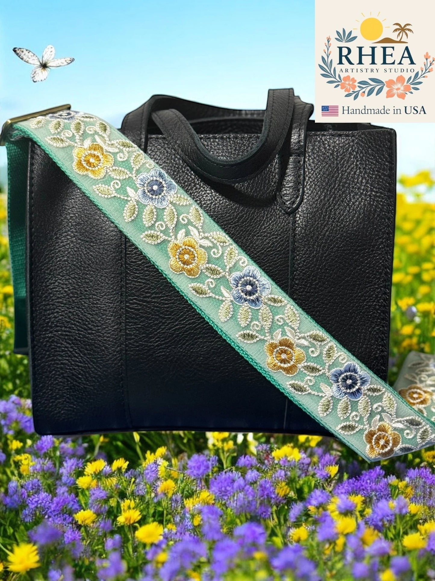 Rhea Artistry Studio mint green crossbody strap with embroidered gold, blue, and white florals, 2-inch width, adjustable length, and brushed brass hardware.