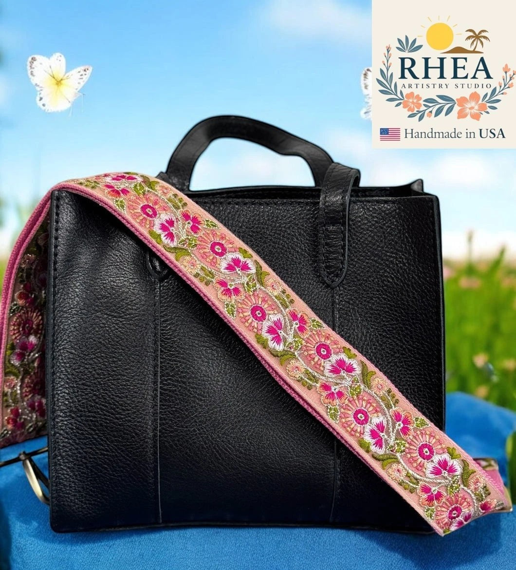 Rhea Artistry Studio pink crossbody strap with embroidered white and pink trillium flowers and green leaves, 2-inch width.