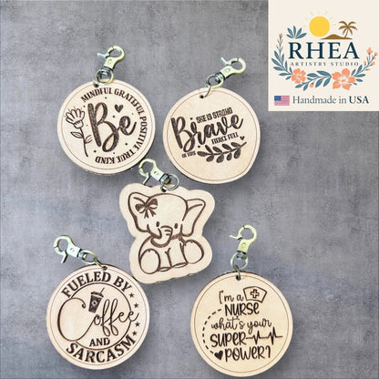 Rhea Artistry Studio engraved leather tags with inspirational quotes and designs, including a cute elephant.