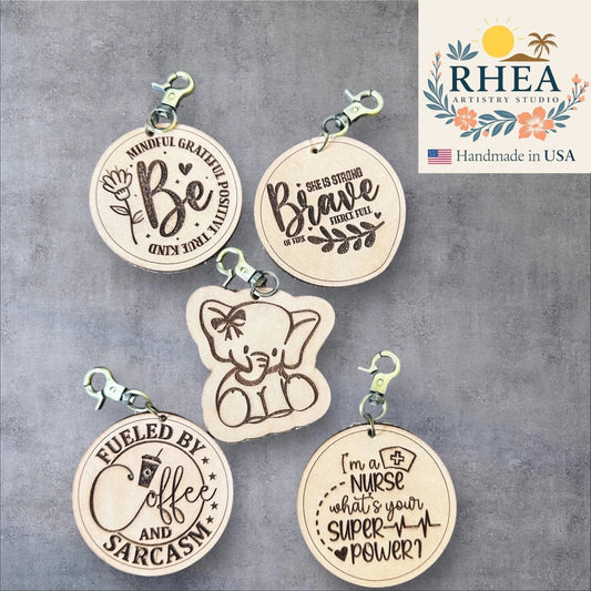 Rhea Artistry Studio engraved leather tags with inspirational quotes and designs, including a cute elephant.
