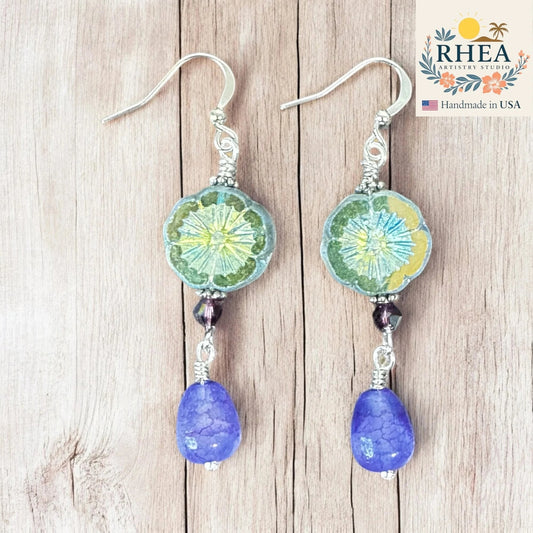 Rhea Artistry Studio green-yellow floral glass bead drop earrings with purple gemstone teardrops and silver hooks.