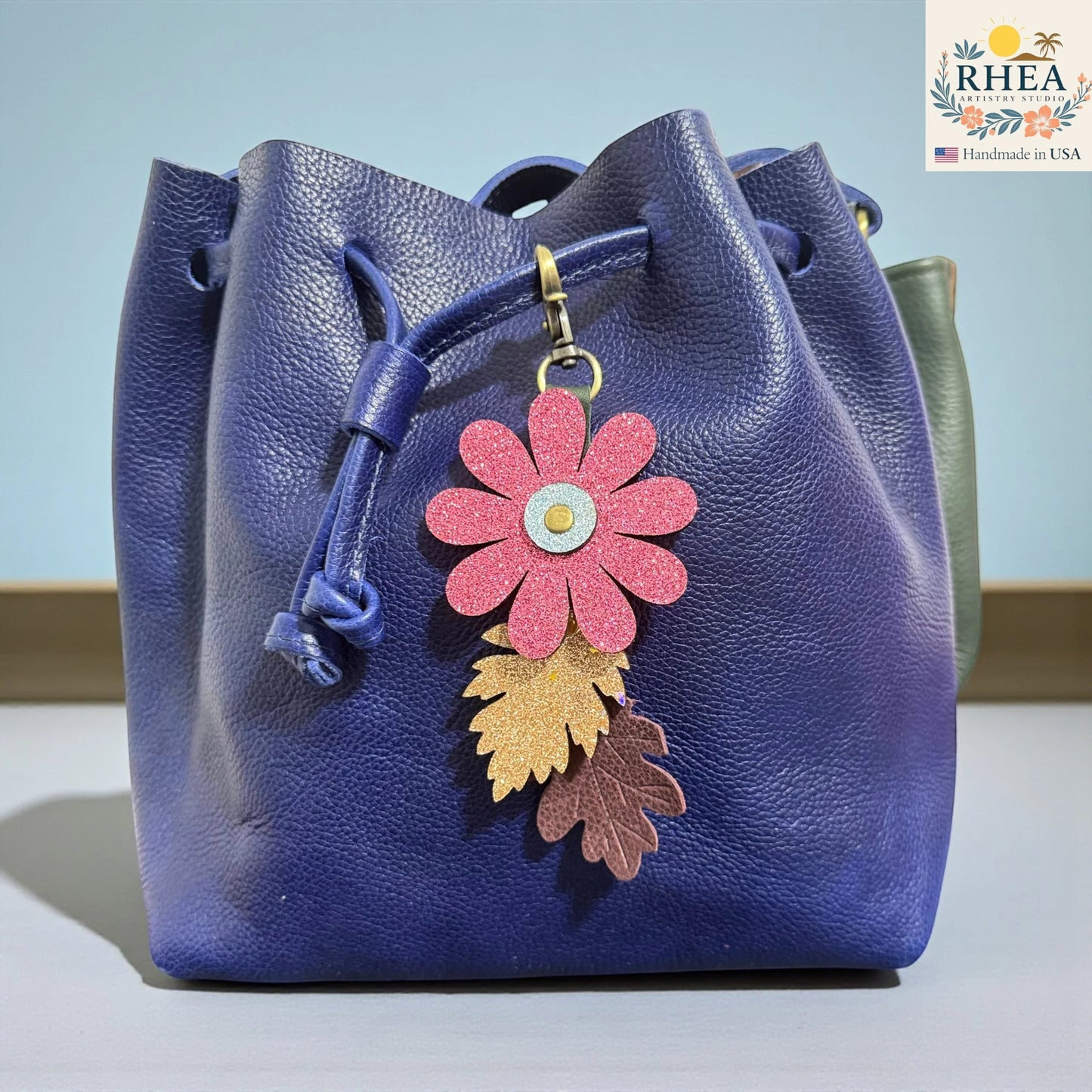 Rhea Artistry Studio glitter flower and embossed leaf leather purse charm, 7" total length, antique brass clasp.