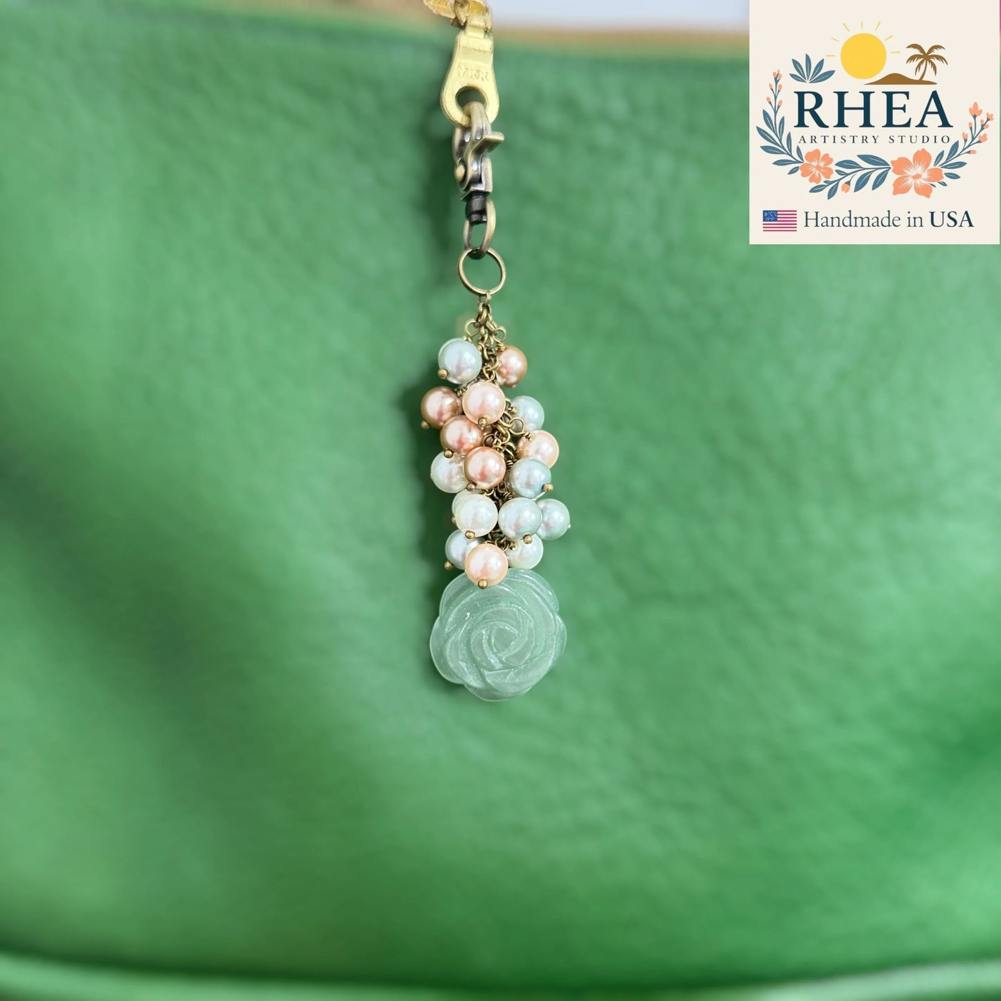 Rhea Artistry Studio handcrafted bag charm with glass pearls and a carved jade rose pendant on antique bronze hardware.