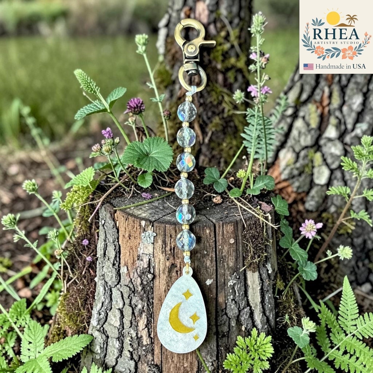 Rhea Artistry Studio bag charm with multi-faceted glass rounds, brass beads, and a moon and stars pendant.