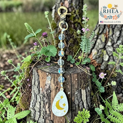 Rhea Artistry Studio bag charm with multi-faceted glass rounds, brass beads, and a moon and stars pendant.