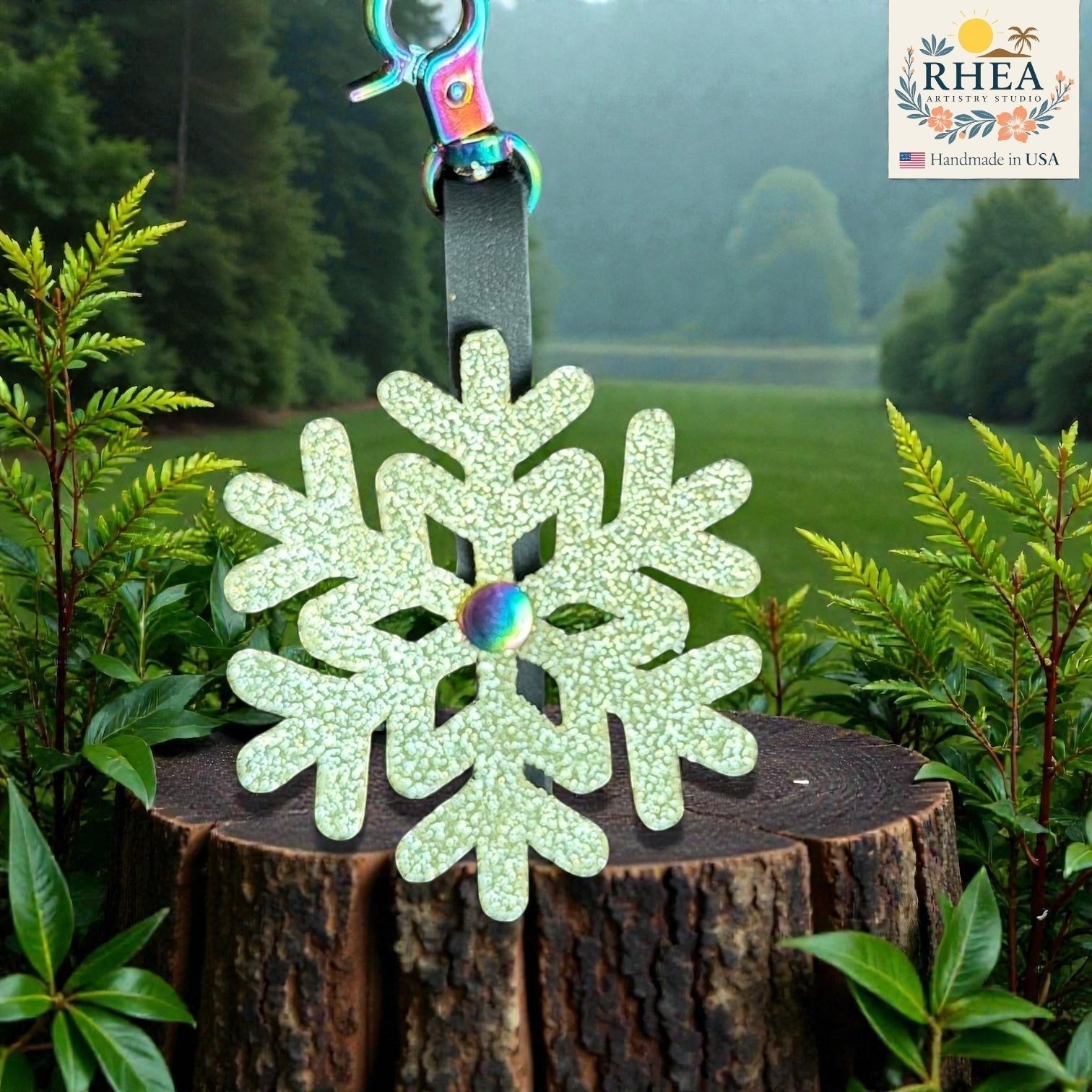 Rhea Artistry Studio light green glitter snowflake leather bag charm with rainbow hardware.