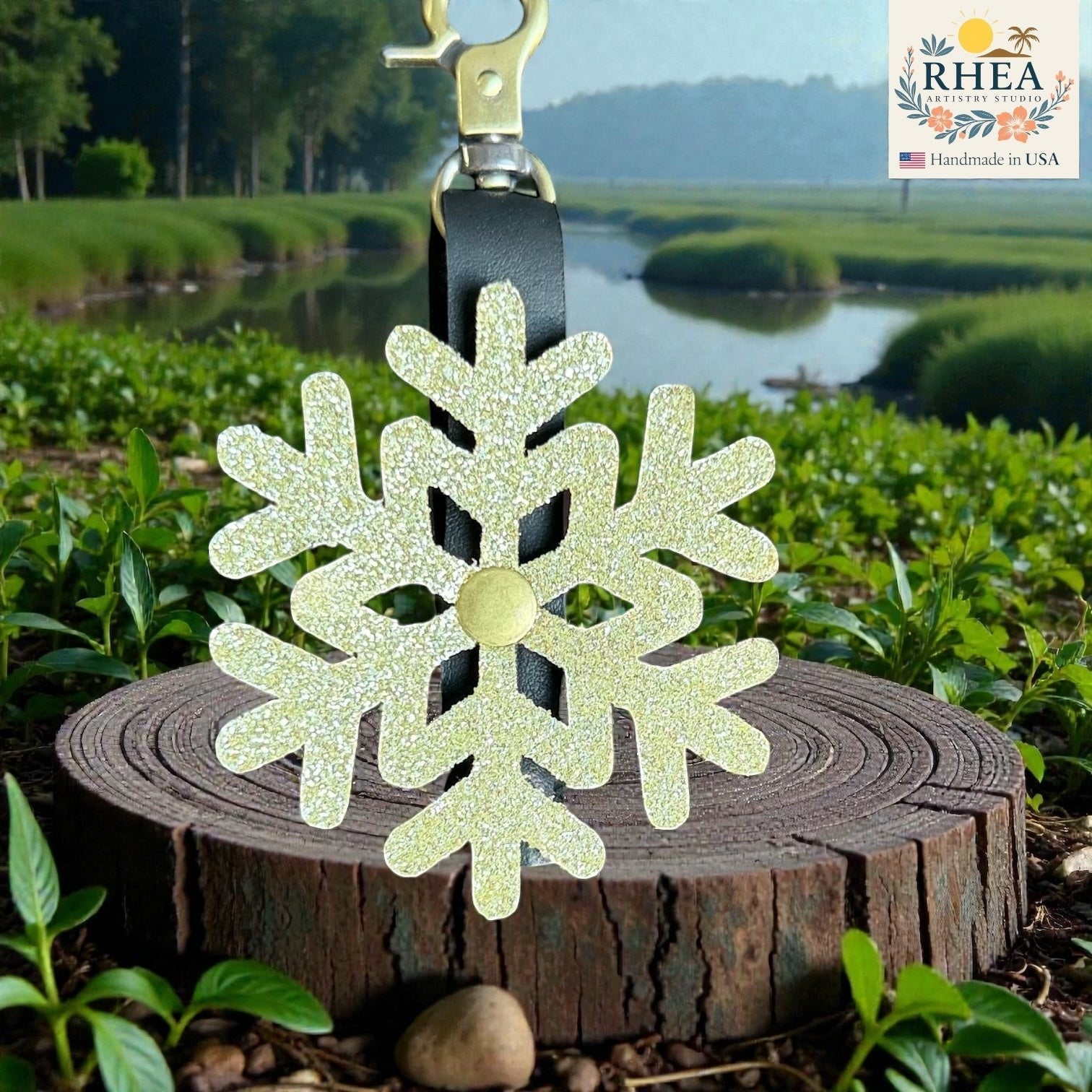 Rhea Artistry Studio glitter snowflake leather charm with gold hardware, perfect for bags and keychains.