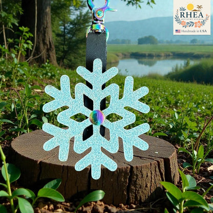 Rhea Artistry Studio light blue glitter snowflake leather charm with rainbow gem accent and rainbow clasp.