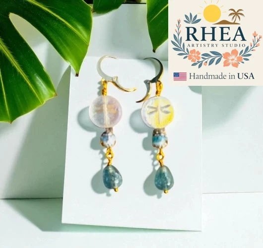 Rhea Artistry Studio gold laser etched dragonfly earrings with Czech glass beads and blue gemstone drops.