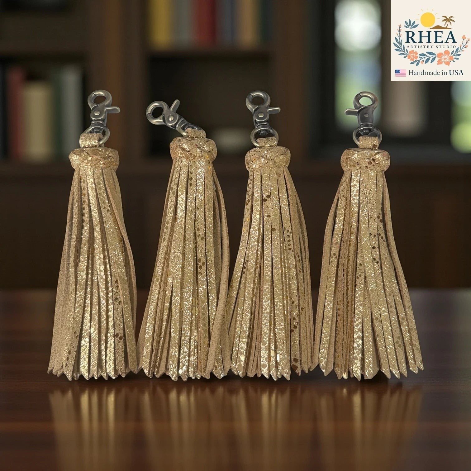 Rhea Artistry Studio handmade gold glitter leather tassel keychain with lobster clasp, 7.25" long.