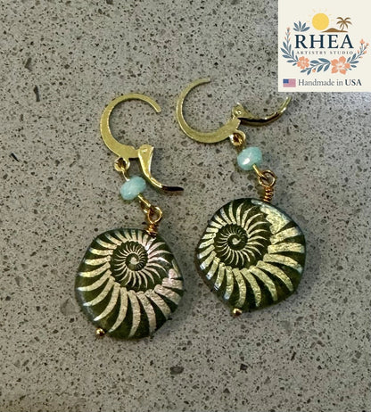Rhea Artistry Studio gold plated brass earrings with laser etched sea foam green Czech glass beads in ammonite fossil design.