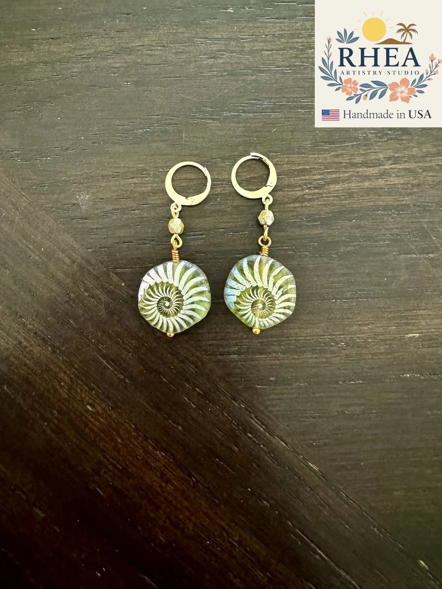 Rhea Artistry Studio handmade 1-inch drop earrings with laser-etched avocado green Czech glass beads and 24k gold plated brass lever backs.