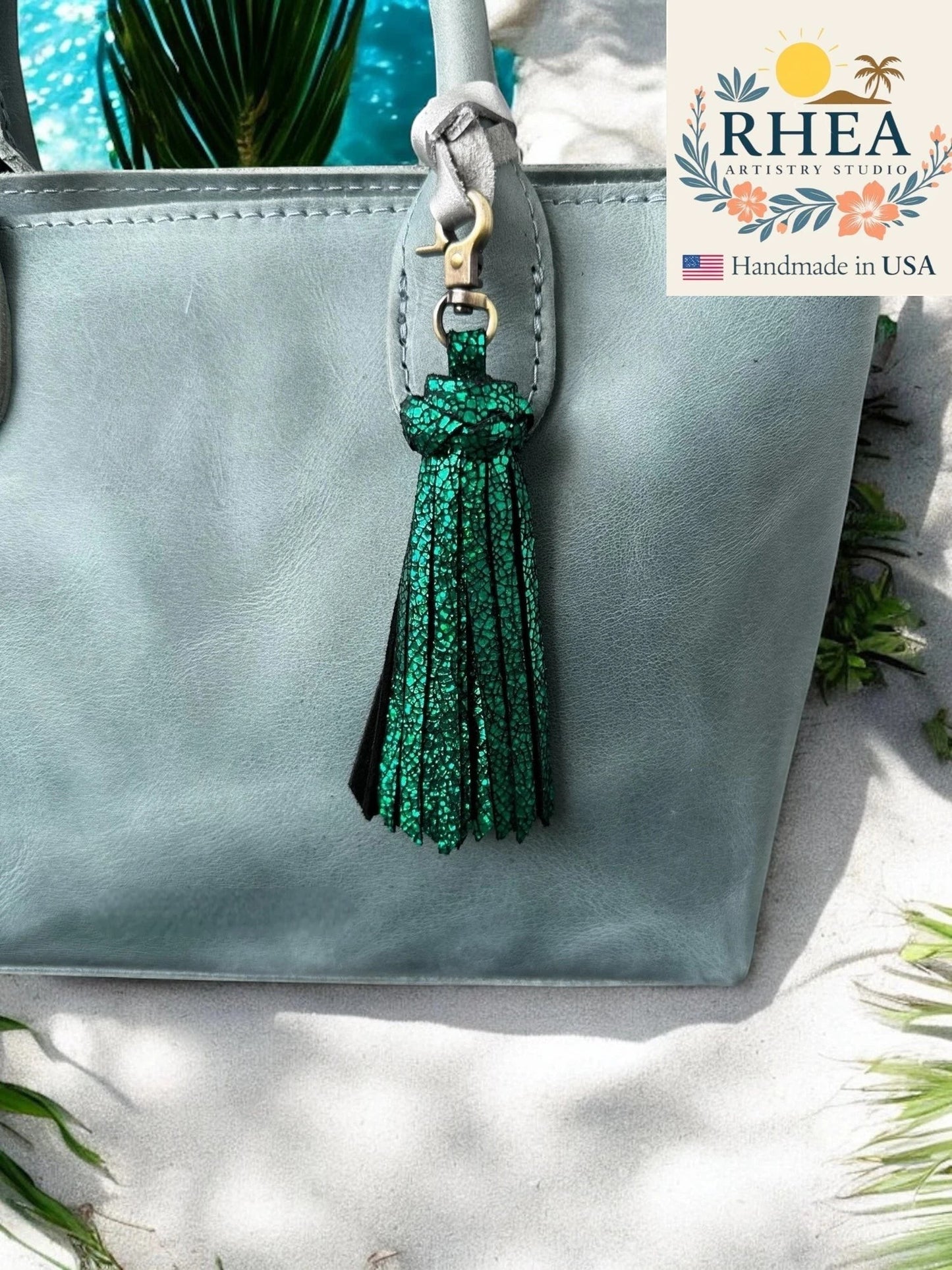 Rhea Artistry Studio handmade green glitter leather tassel bag charm with lobster clasp.