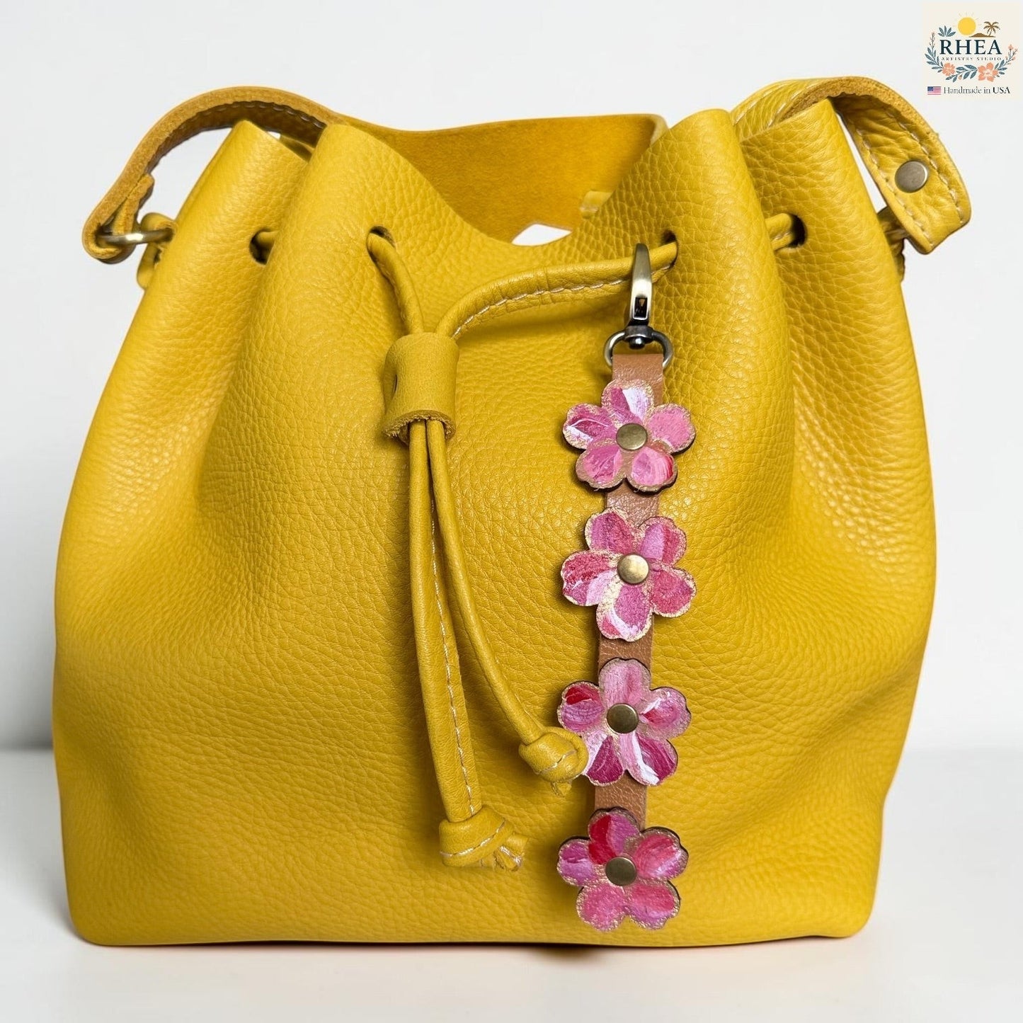 Rhea Artistry Studio Hand-Painted Leather Flower Bag Charm featuring Berry Blush organic leather flowers with pink, coral, cream, and brass details.