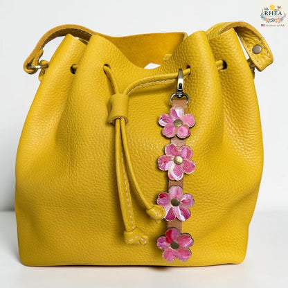 Rhea Artistry Studio Hand-Painted Leather Flower Bag Charm featuring Berry Blush organic leather flowers with pink, coral, cream, and brass details.