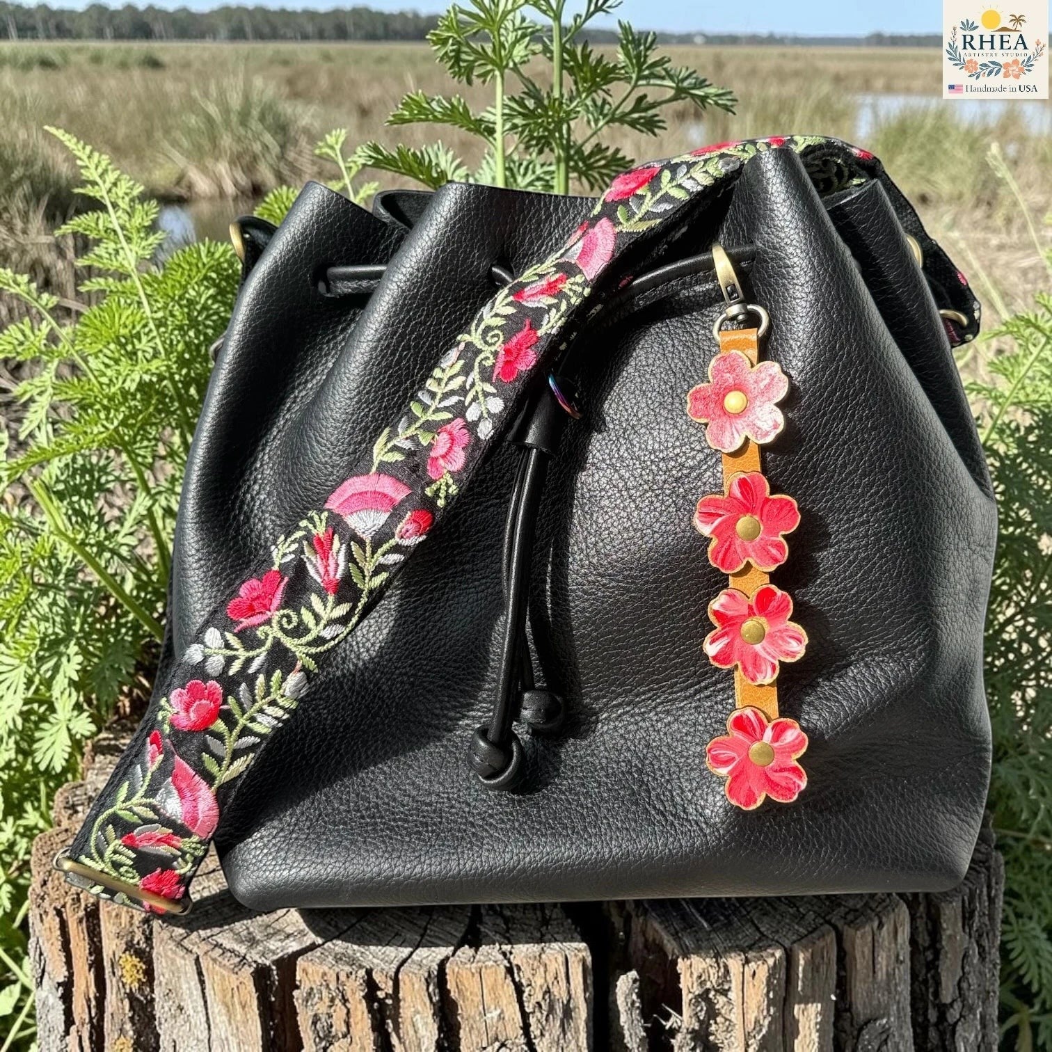 Rhea Artistry Studio Hand-Painted Leather Flower Bag Charm with colorful organic leather flowers, brass hardware, and a lightweight clip-on design for handbags and totes.