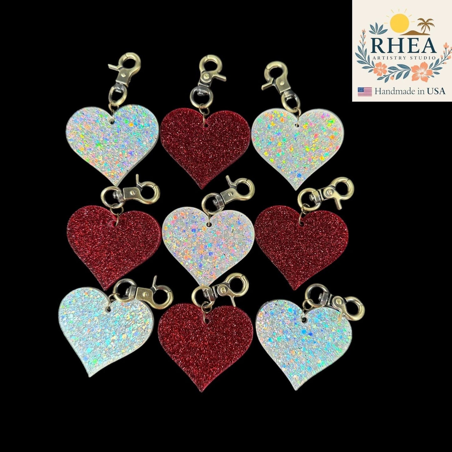 Rhea Artistry Studio red and holographic glitter heart charms with antique brass clasps, perfect for bags or zippers.