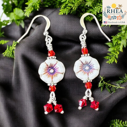Rhea Artistry Studio white hibiscus floral glass bead earrings with red crystal accents and silver-plated hooks.