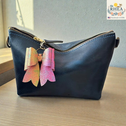 Rhea Artistry Studio handmade holographic pink and orange double-layer French bow bag charm with brass hardware.