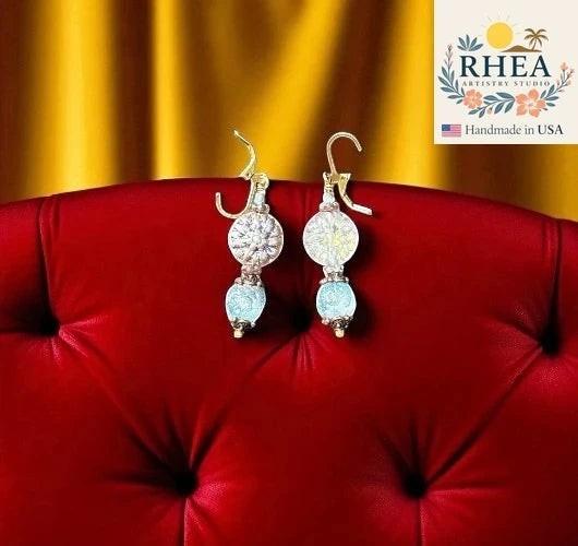 Rhea Artistry Studio icy blue and silver glass dahlia floral earrings with brass hardware, approx. 1.5-2 inches long.
