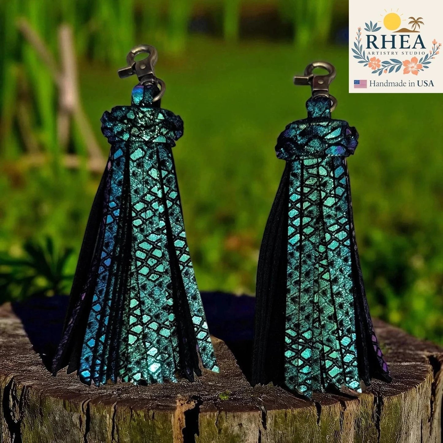 Rhea Artistry Studio handmade iridescent teal leather tassel keychain with antique brass lobster clasp, approx. 5 inches long.