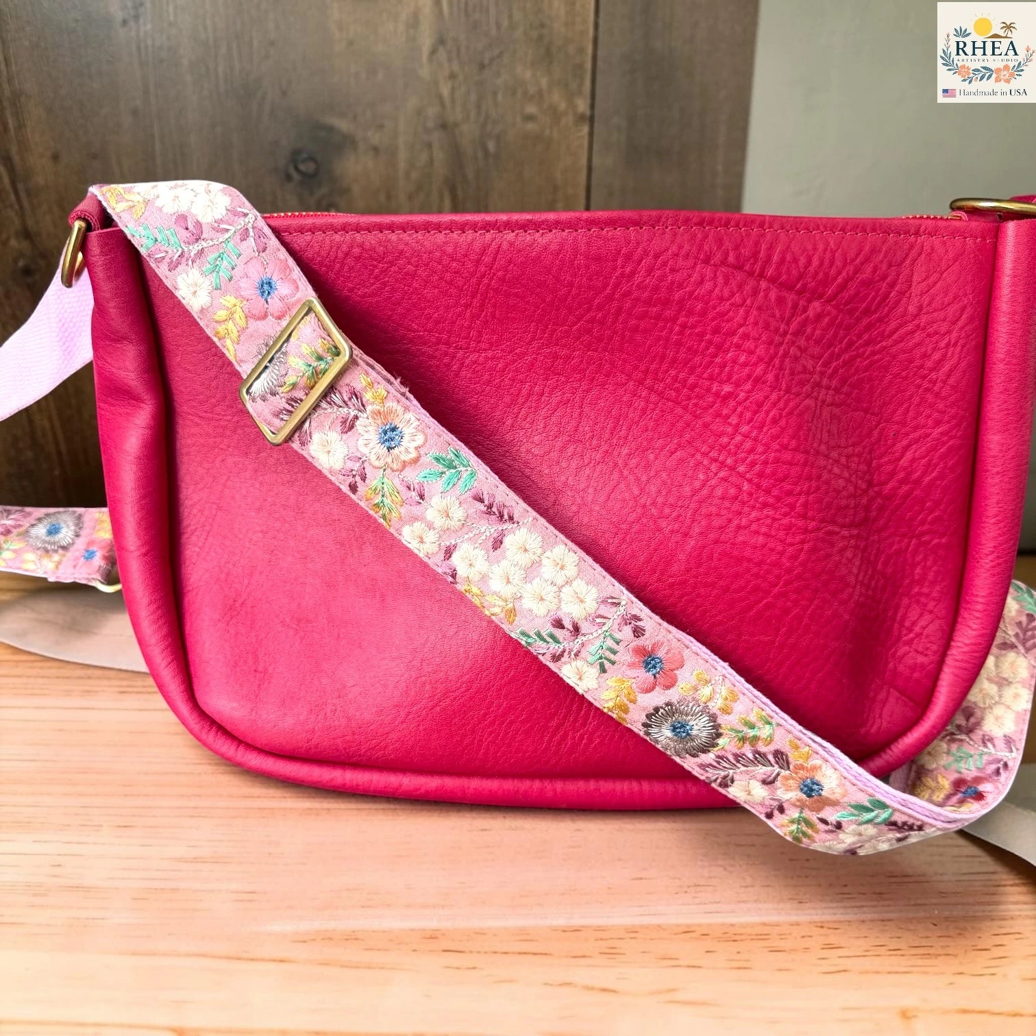 Rhea Artistry Studio ivory crossbody strap with pastel pink, yellow, and mint floral embroidery, 1.5-inch width, adjustable length.