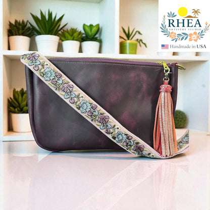 Rhea Artistry Studio lavender and silver embroidered crossbody strap with floral detail on a purple leather bag.