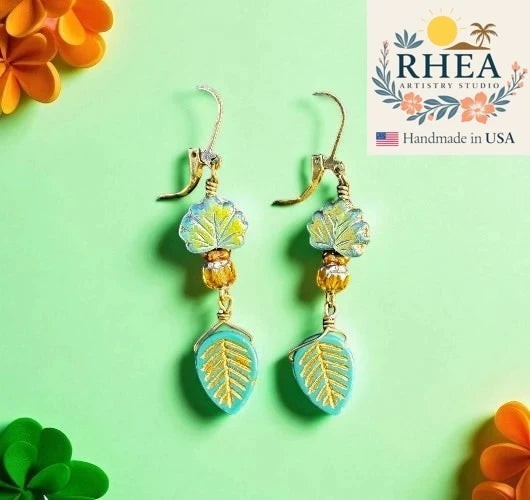 Rhea Artistry Studio handmade teal and yellow glass leaf drop earrings with brass hardware, approx. 2 inches long.