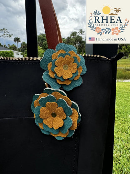 Rhea Artistry Studio handmade turquoise and yellow double leather flower bag charm with brass rivets.