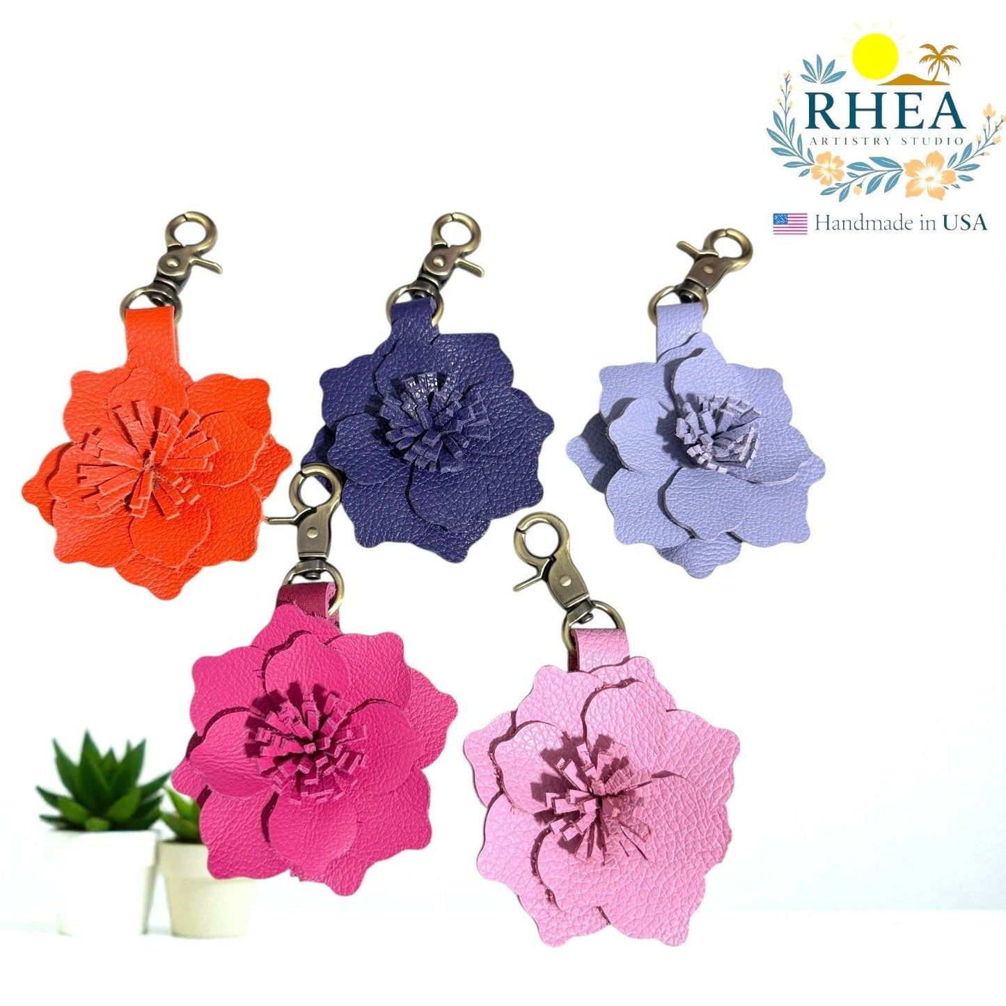 Rhea Artistry Studio orange, navy, lavender, hot pink, and light pink leather flower charms. Handcrafted floral accessory for bags, purses, or keychains.