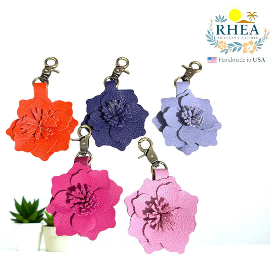 Rhea Artistry Studio orange, navy, lavender, hot pink, and light pink leather flower charms. Handcrafted floral accessory for bags, purses, or keychains.