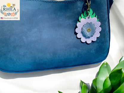 Rhea Artistry Studio blue leather monstera leaf and flower charm with brass clasp, 3 inches long.