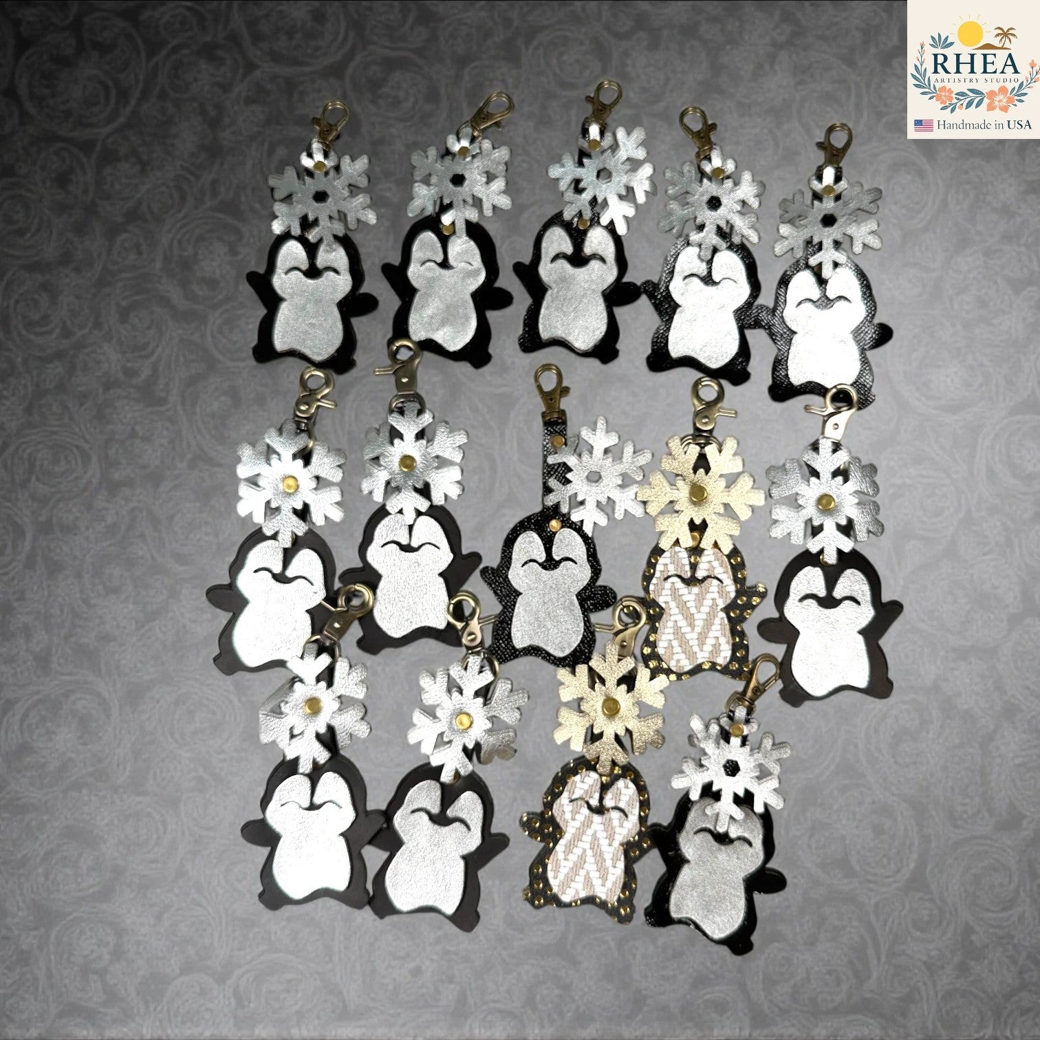 Rhea Artistry Studio handmade leather penguin bag charm with snowflake detail. Available in black and white.