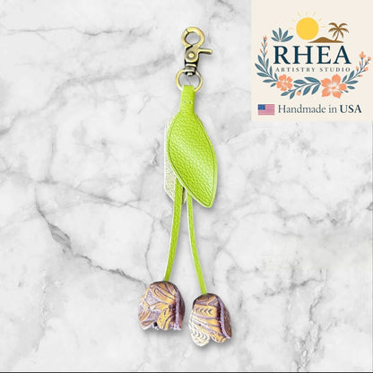 Rhea Artistry Studio lime green leather tulip charm with gold patterned flower details and brass lobster clasp.
