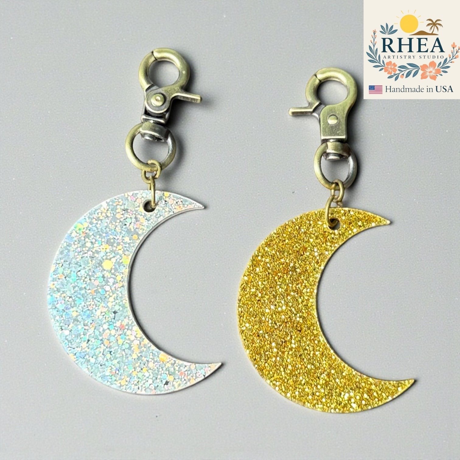 Rhea Artistry Studio gold glitter and holographic glitter moon charms with brass clasps.