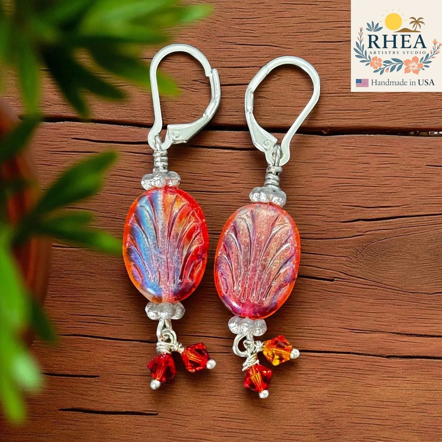 Rhea Artistry Studio Phoenix Flame earrings with oval Czech glass beads in orange, red, and blue, accented with red and amber crystals.