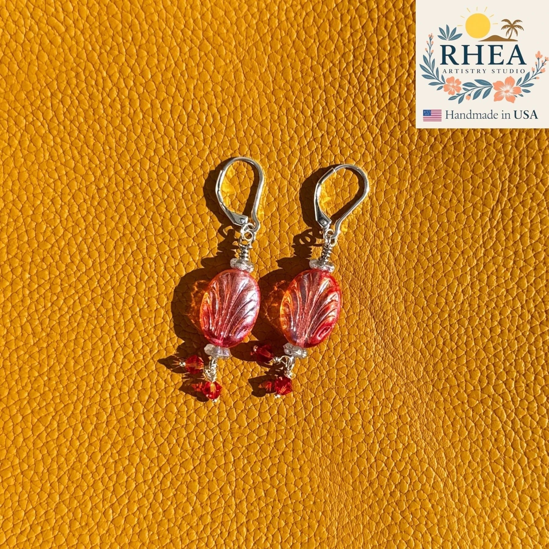 Rhea Artistry Studio Phoenix Flame earrings with oval red-orange Czech glass beads and red crystal accents, silver lever-back closures.