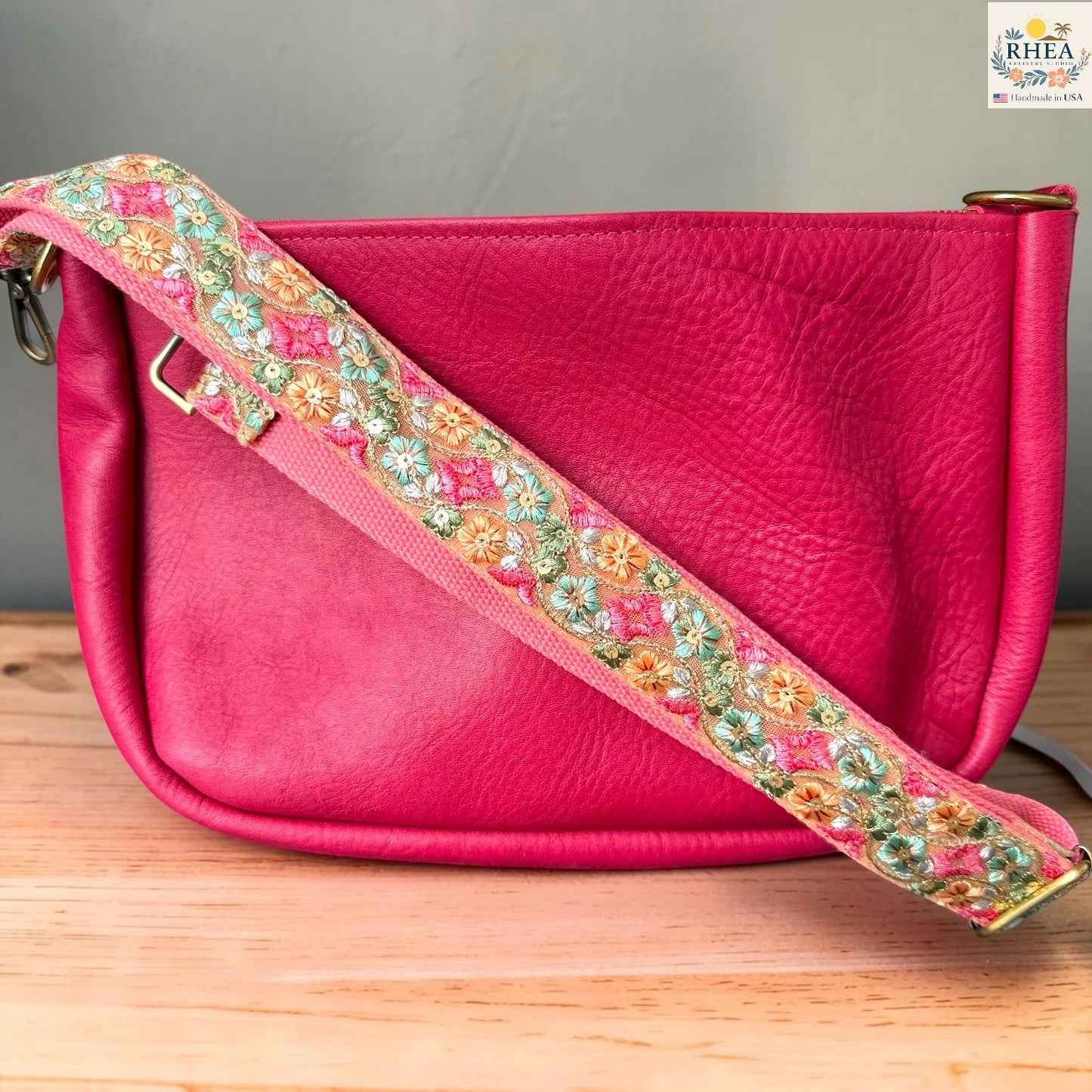Rhea Artistry Studio blush pink crossbody strap with green, orange, and pink diamond floral embroidery, 2-inch width, adjustable length.