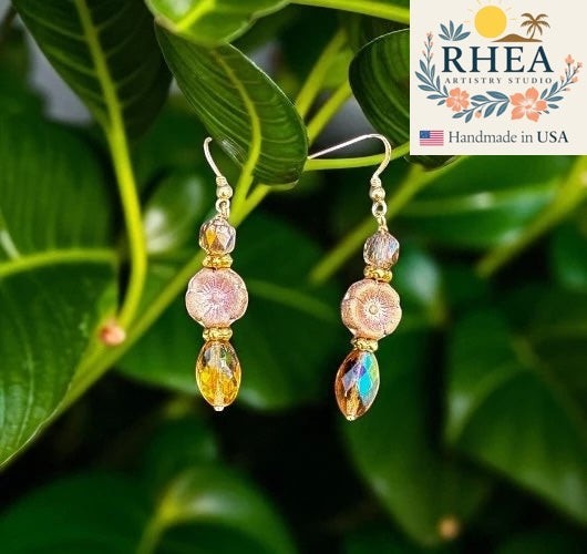 Rhea Artistry Studio pink hibiscus glass flower earrings with gold-filled findings and faceted amber drops.