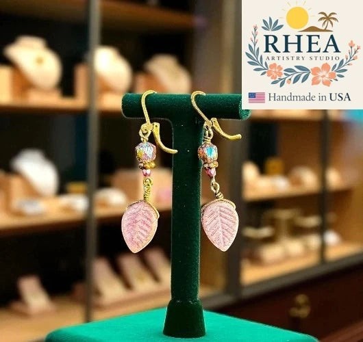 Rhea Artistry Studio pink leaf Czech glass earrings with bronze accents and brass hardware, approx. 2 inches long.