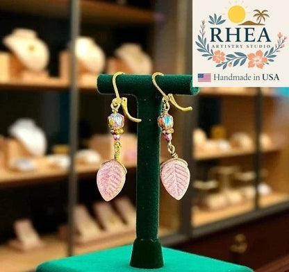 Rhea Artistry Studio pink leaf Czech glass earrings with bronze accents and brass hardware, approx. 2 inches long.
