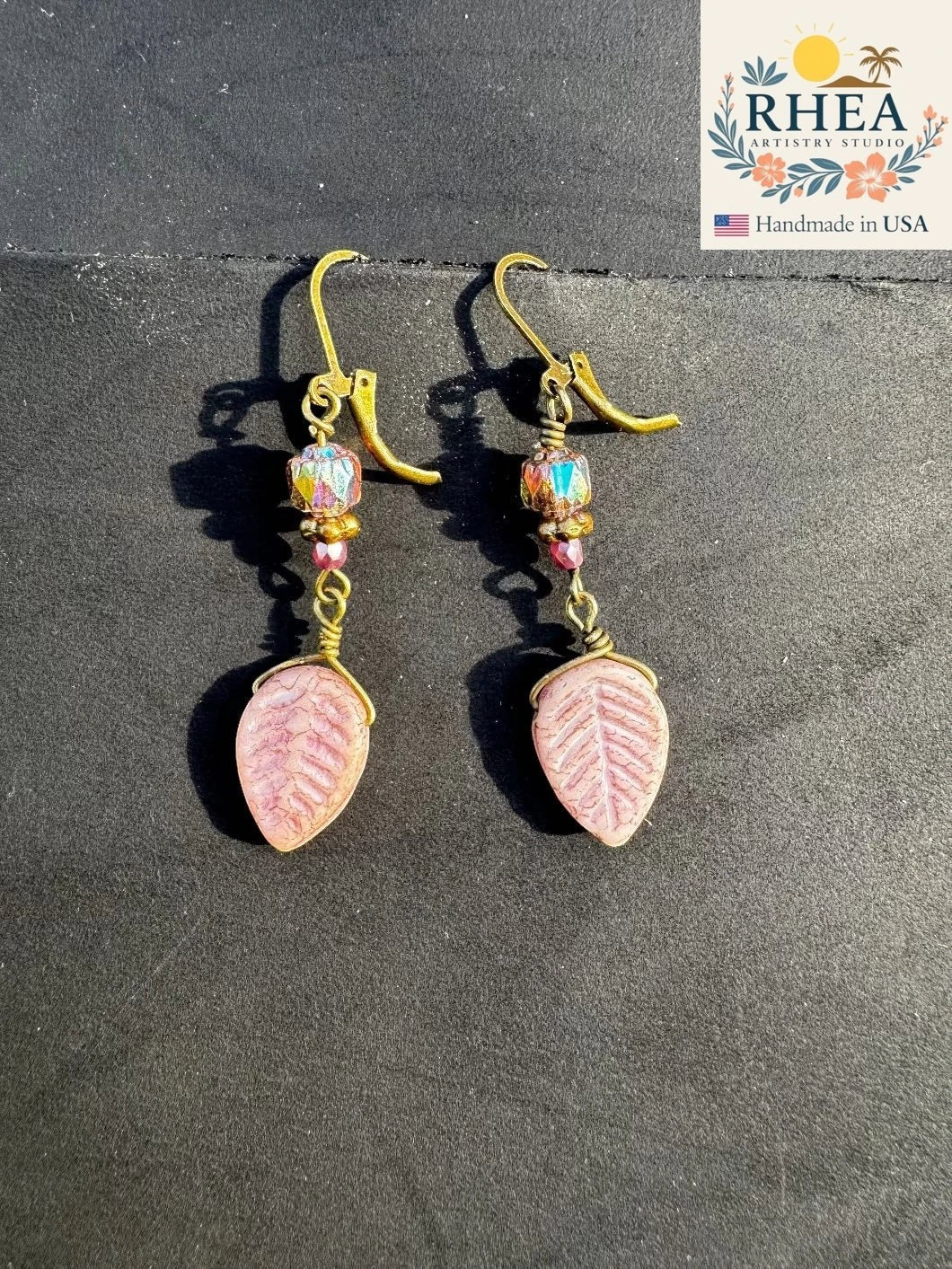Rhea Artistry Studio pink leaf Czech glass earrings with iridescent beads and bronze accents, approx. 2 inches long.