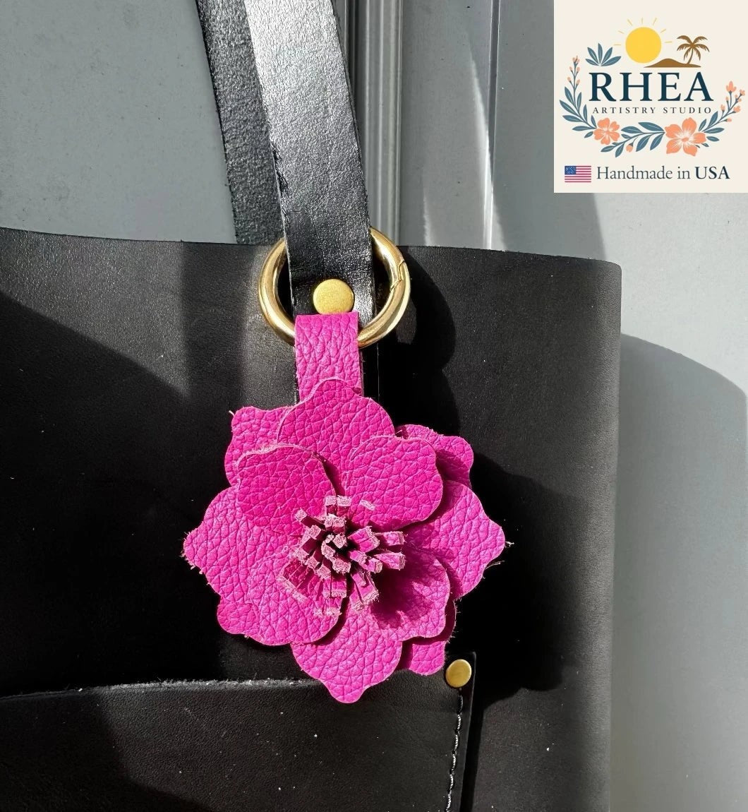 Rhea Artistry Studio large pink leather hibiscus flower bag charm with hand-cut stamen and gold hardware.