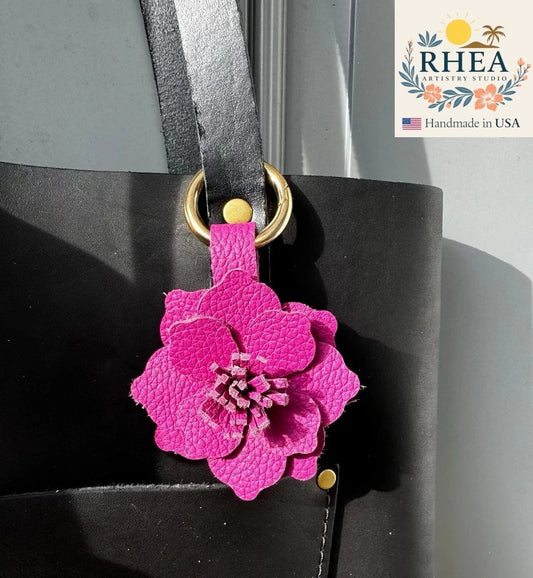 Rhea Artistry Studio large pink leather hibiscus flower bag charm with hand-cut stamen and gold hardware.