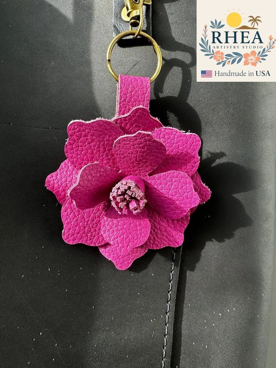 Rhea Artistry Studio large pink leather flower bag charm with a 3-inch hibiscus design and lobster clasp.