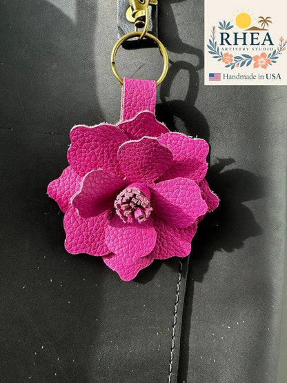 Rhea Artistry Studio large pink leather flower bag charm with a 3-inch hibiscus design and lobster clasp.