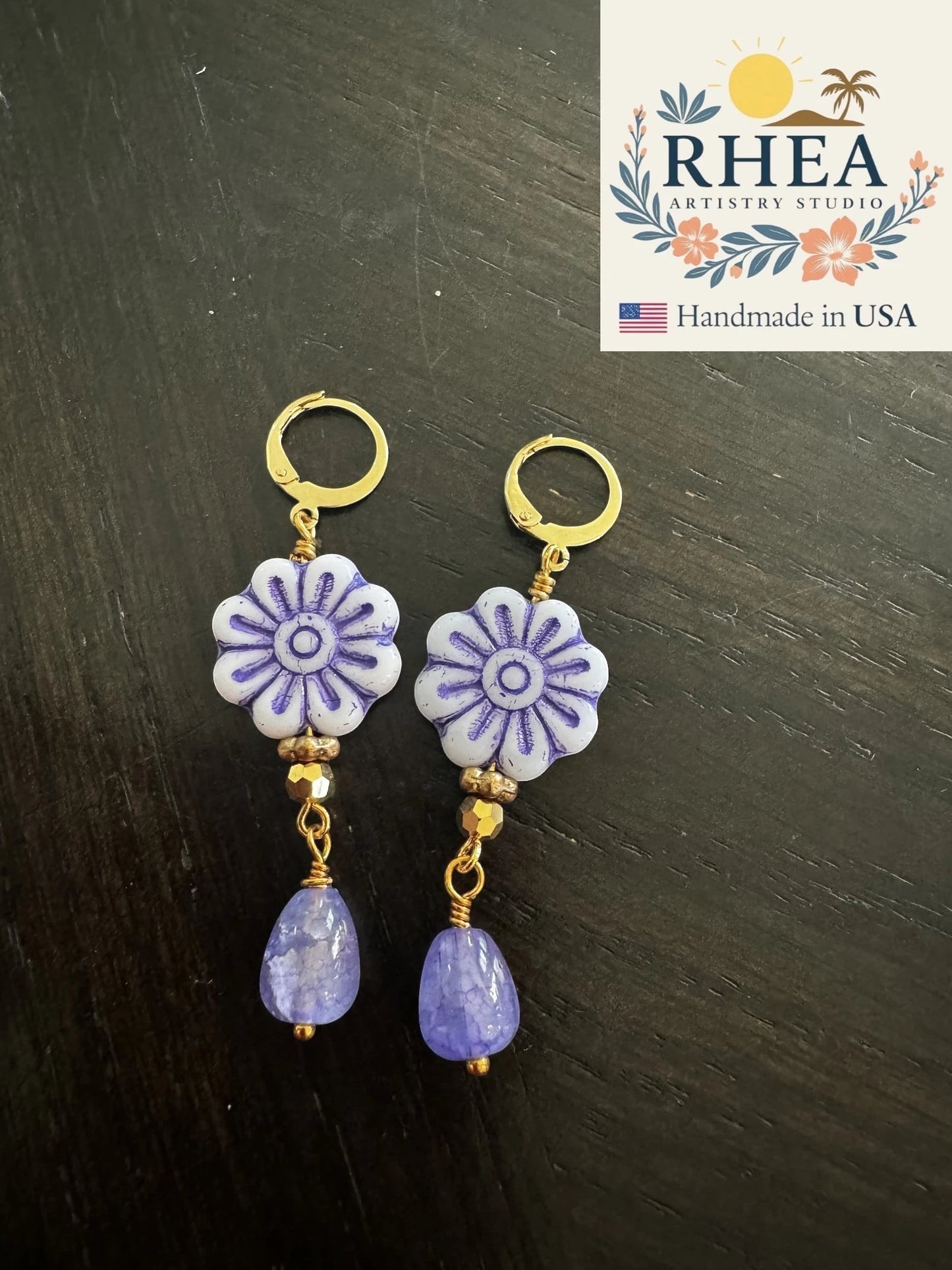 Rhea Artistry Studio white and purple daisy flower drop earrings with faceted lavender gemstone beads and gold plated brass findings.