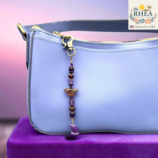 Rhea Artistry Studio purple gemstone and Czech bead bag charm with crescent moon pendant and brass clasp.