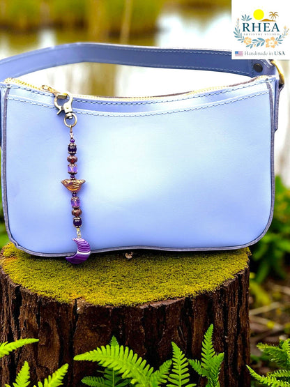 Rhea Artistry Studio purple gemstone and Czech bead bag charm with crescent moon pendant and brass clasp.